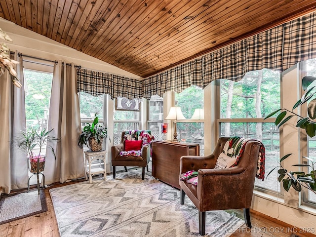 sunroom / solarium with lofted ceiling, wood ceiling, and hardwood / wood-style flooring