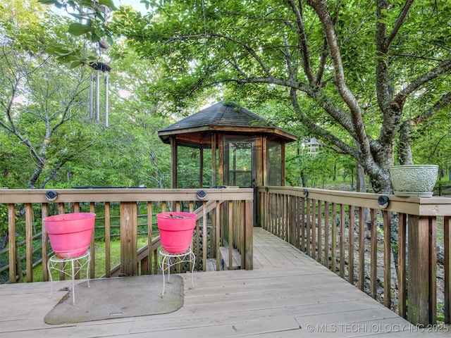 wooden terrace featuring a gazebo