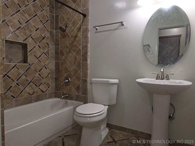 full bath with baseboards, toilet, and shower / bathtub combination