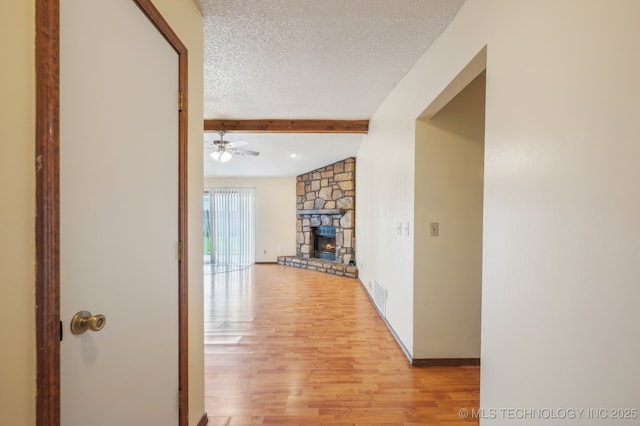 2925 S 125th E Ave, Tulsa, OK 74129 - corridor featuring light wood-type flooring, beam ceiling, and a textured ceiling