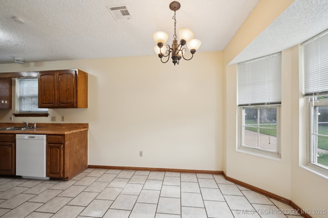 2925 S 125th E Ave, Tulsa, OK 74129 - kitchen with dishwasher, a sink, a chandelier, hanging light fixtures, and baseboards
