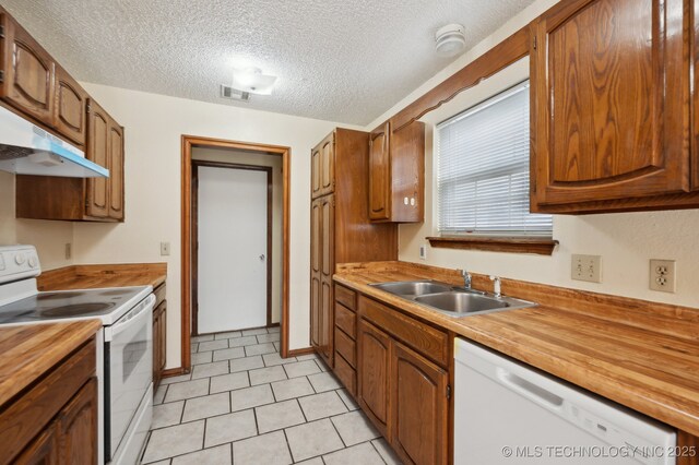 2925 S 125th E Ave, Tulsa, OK 74129 - kitchen with white appliances, a sink, wood counters, a textured ceiling, and under cabinet range hood