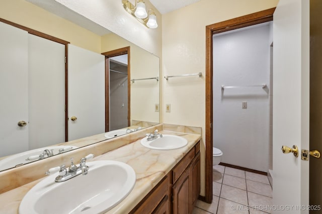 2925 S 125th E Ave, Tulsa, OK 74129 - bathroom featuring toilet, tile patterned floors, double vanity, and baseboards