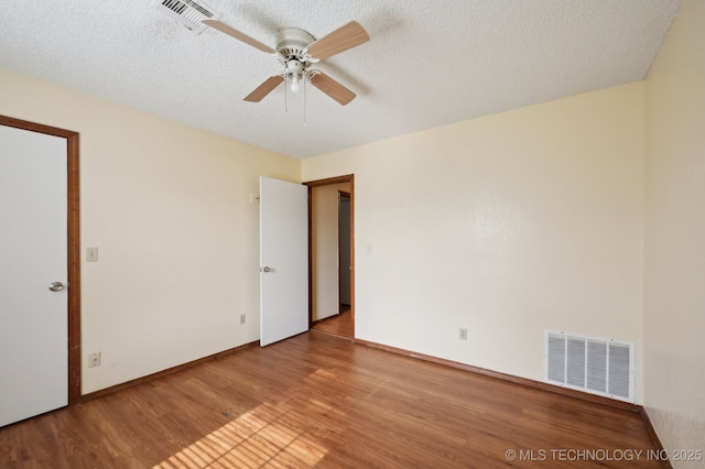 2925 S 125th E Ave, Tulsa, OK 74129 - empty room featuring a ceiling fan, wood finished floors, a textured ceiling, and baseboards