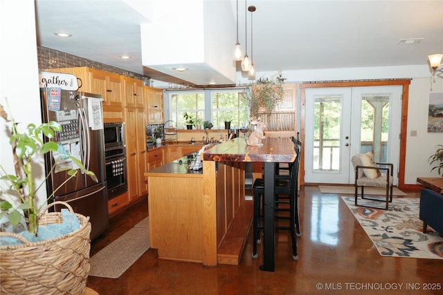 72413 S 4750th Rd, Westville, OK 74965 - kitchen featuring stainless steel appliances, concrete flooring, a kitchen bar, a sink, and pendant lighting