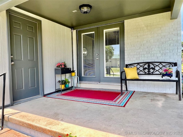 205 NE 1st St, Kingston, OK 73439 - entrance to property with french doors and a porch