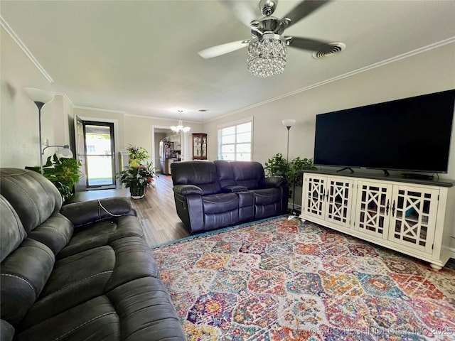 205 NE 1st St, Kingston, OK 73439 - living area with a chandelier, ornamental molding, wood finished floors, and ceiling fan