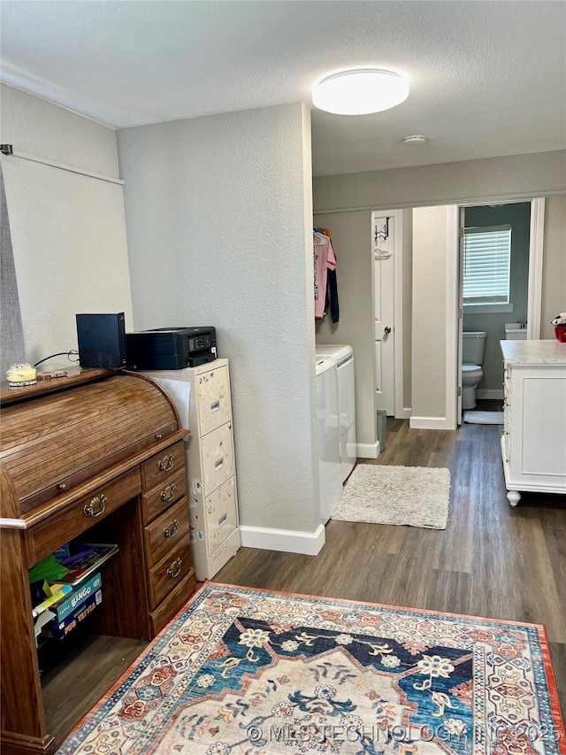 205 NE 1st St, Kingston, OK 73439 - home office featuring dark wood-style flooring, washer and dryer, and baseboards
