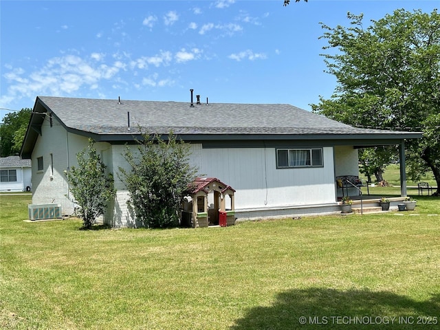 205 NE 1st St, Kingston, OK 73439 - back of house with a lawn, roof with shingles, and central AC unit