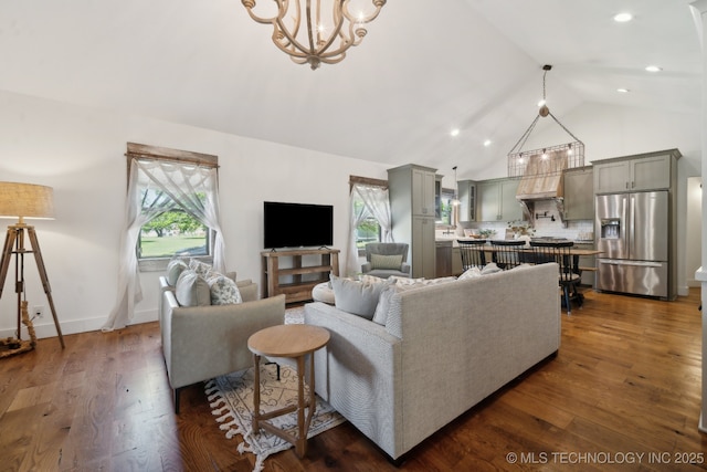 living area with a chandelier, dark wood-type flooring, high vaulted ceiling, and recessed lighting