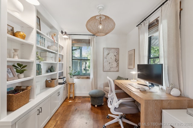 home office with healthy amount of natural light and light wood-style flooring