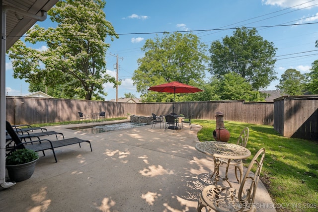 view of patio with a storage shed, an outdoor structure, and outdoor dining space