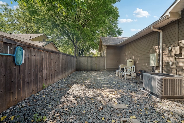 fenced backyard featuring central air condition unit
