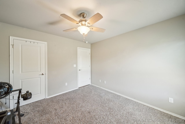 unfurnished bedroom with carpet flooring, baseboards, and ceiling fan