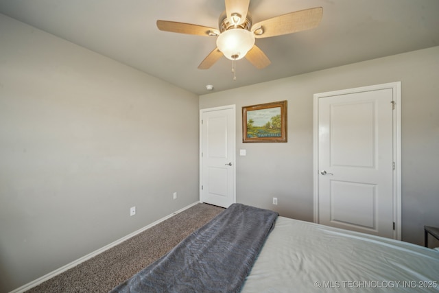 carpeted bedroom with baseboards and ceiling fan