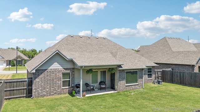 back of property featuring brick siding, a patio area, and a shingled roof