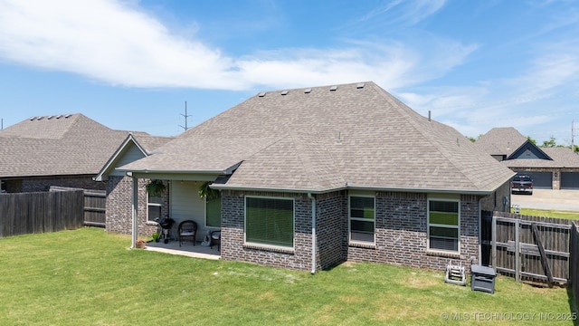 back of property featuring brick siding, a patio, and a shingled roof