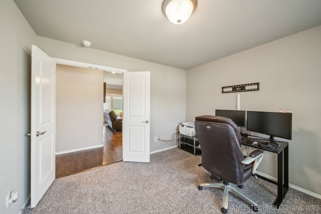 carpeted home office featuring baseboards
