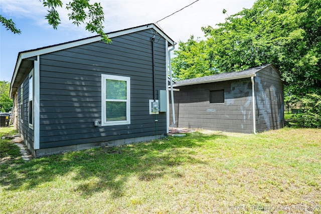 2017 N Quaker Ave, Tulsa, OK 74106 - rear view of property featuring a yard, central AC unit, and an outbuilding