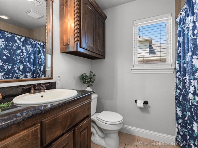 1912 Lester Ave, Bartlesville, OK 74006 - full bathroom featuring tile patterned floors, vanity, toilet, baseboards, and a shower with shower curtain