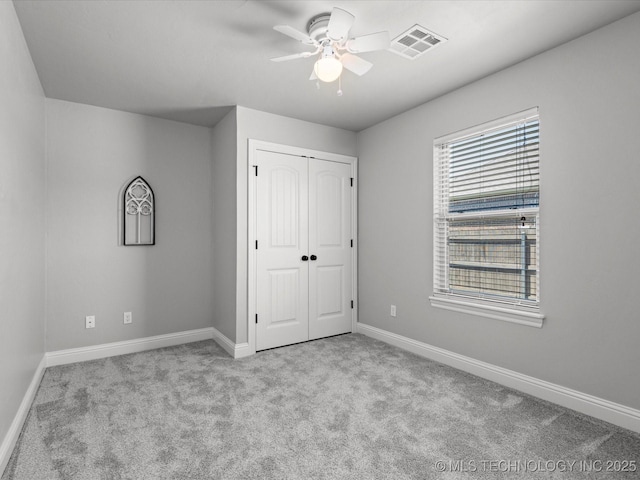 1912 Lester Ave, Bartlesville, OK 74006 - unfurnished bedroom with carpet, baseboards, a closet, and a ceiling fan