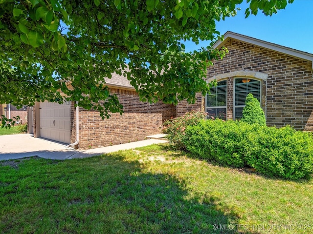 1912 Lester Ave, Bartlesville, OK 74006 - view of grassy yard with driveway and an attached garage