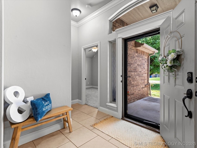 1912 Lester Ave, Bartlesville, OK 74006 - foyer with light tile patterned floors, ornamental molding, baseboards, and light carpet