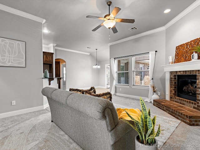 1912 Lester Ave, Bartlesville, OK 74006 - living area featuring carpet flooring, a ceiling fan, arched walkways, baseboards, and ornamental molding