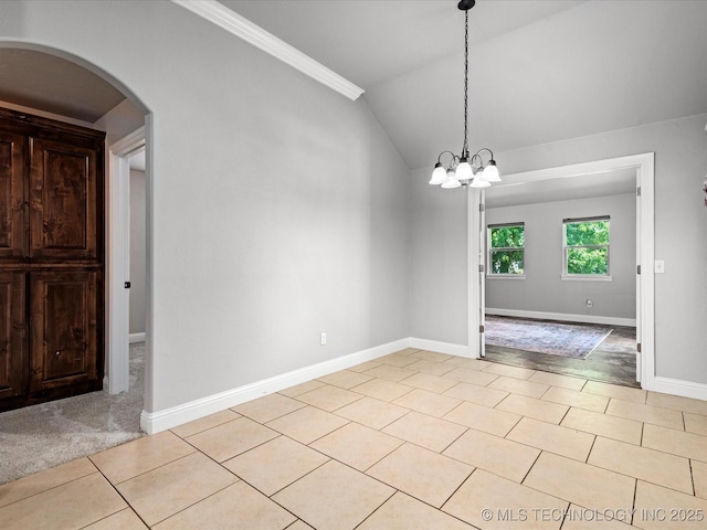 1912 Lester Ave, Bartlesville, OK 74006 - empty room featuring arched walkways, light tile patterned floors, baseboards, lofted ceiling, and a chandelier