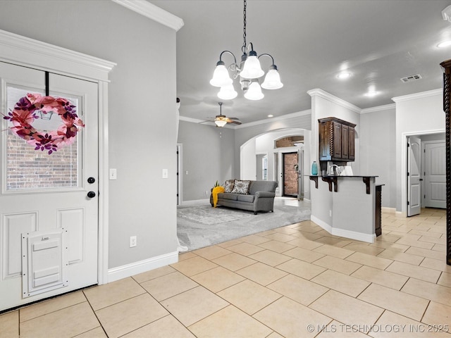 1912 Lester Ave, Bartlesville, OK 74006 - entryway with arched walkways, light tile patterned floors, ornamental molding, light carpet, and baseboards