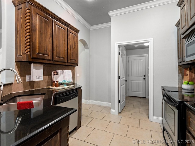 1912 Lester Ave, Bartlesville, OK 74006 - kitchen with stainless steel appliances, arched walkways, ornamental molding, decorative backsplash, and baseboards