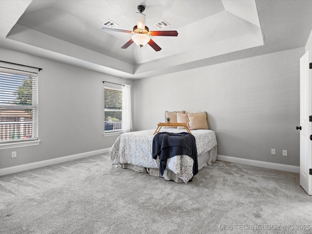 1912 Lester Ave, Bartlesville, OK 74006 - carpeted bedroom featuring a raised ceiling, baseboards, and ceiling fan