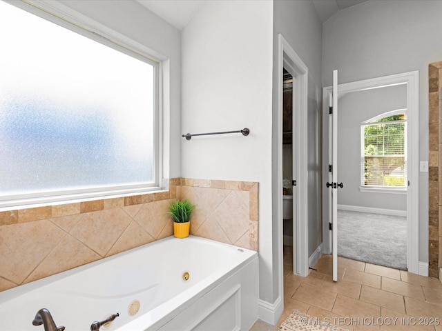 1912 Lester Ave, Bartlesville, OK 74006 - bathroom featuring a whirlpool tub, tile patterned flooring, baseboards, and toilet