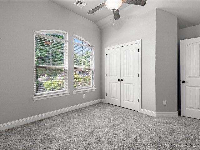 1912 Lester Ave, Bartlesville, OK 74006 - unfurnished bedroom with carpet flooring, lofted ceiling, baseboards, a closet, and ceiling fan