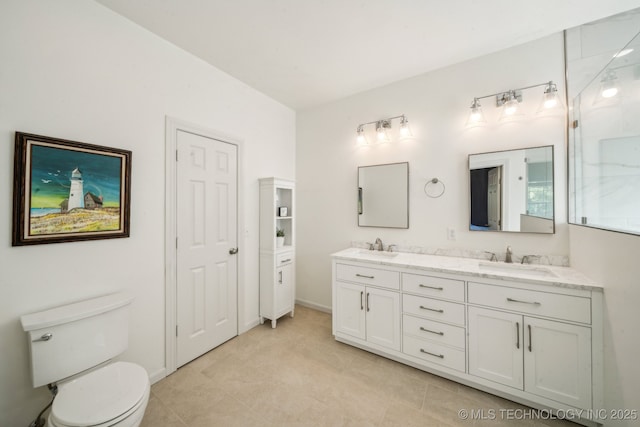 full bath with double vanity, toilet, and tile patterned floors