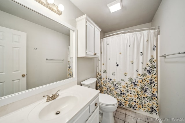 bathroom with toilet, tile patterned flooring, vanity, and curtained shower