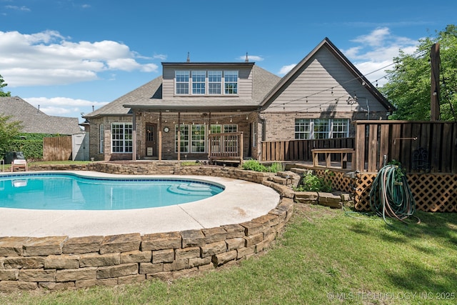 view of swimming pool with a deck