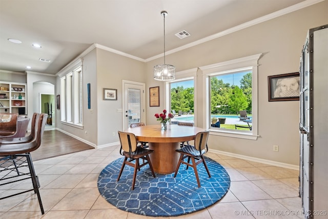 dining area with light tile patterned floors, crown molding, plenty of natural light, baseboards, and recessed lighting