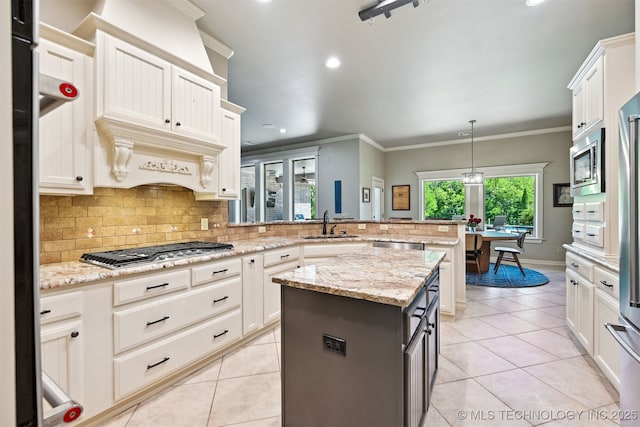 kitchen with a peninsula, stainless steel appliances, light tile patterned floors, tasteful backsplash, and crown molding