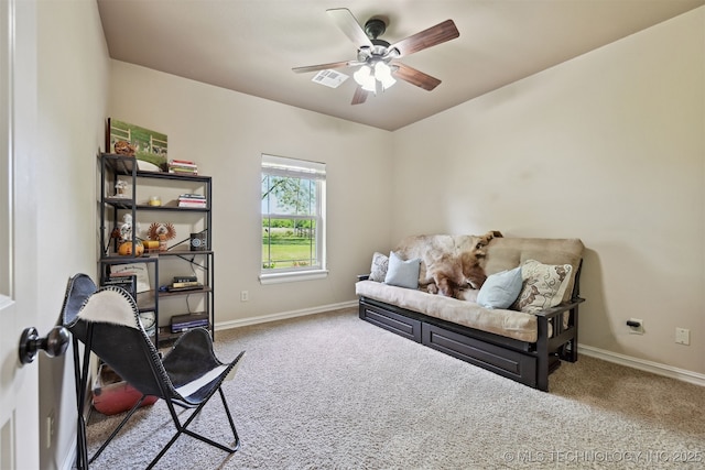 living area with carpet floors, baseboards, and ceiling fan