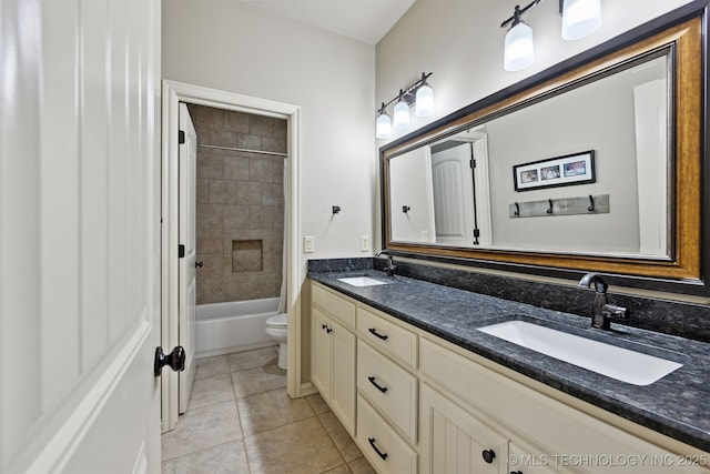 bathroom with double vanity, toilet, tile patterned floors, and shower / tub combination