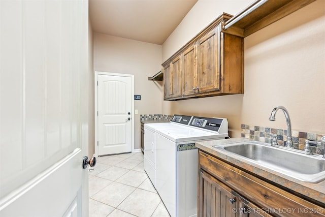 laundry area with washer and clothes dryer, cabinet space, and light tile patterned flooring