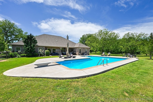 swimming pool with a patio and a diving board