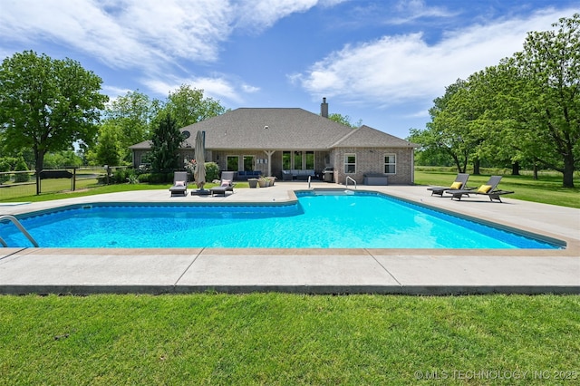 outdoor pool with a patio area