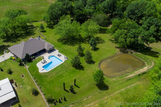 aerial view of property and surrounding area featuring a pool area and a nearby body of water