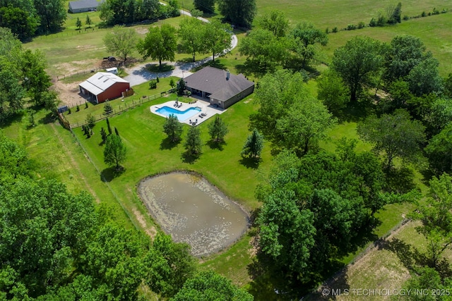 bird's eye view of a pool area and a large body of water