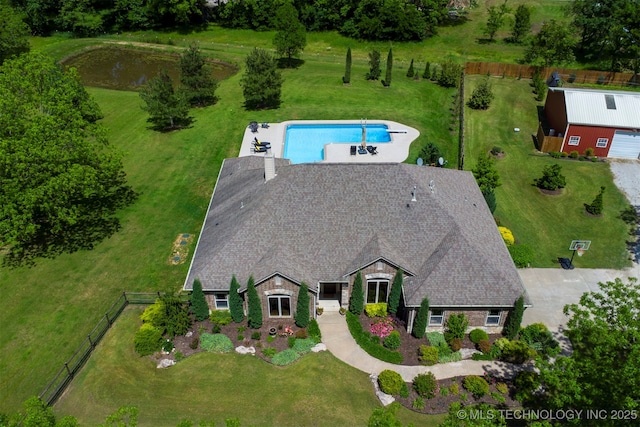 view of subject property with a pool area and a large body of water