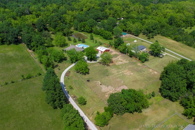 aerial overview of property's location featuring a forest and rural landscape