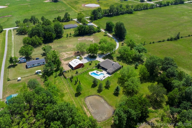 aerial view of property's location featuring rural landscape, a pool, and agricultural land