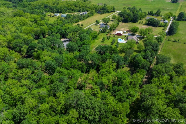 view of rural area with a heavily wooded area